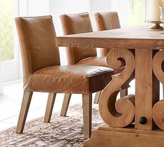 a wooden table with chairs around it