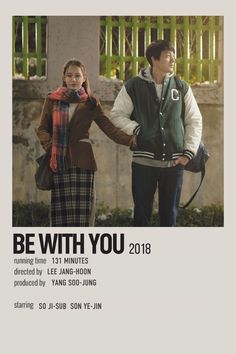 a man and woman standing next to each other in front of an advertisement for be with you