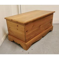 a wooden chest sitting on top of a floor