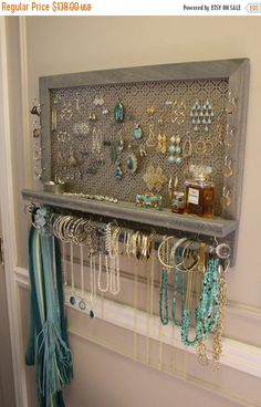 a shelf with jewelry hanging from it's sides