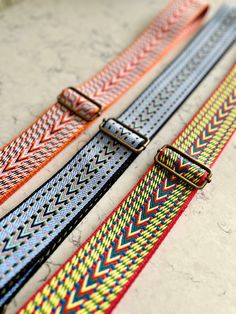 "These colourful webbing straps make it easy to change the look of your favourite bag, just clip them on to a bag that has D rings and you're done!   Lightweight, durable and comfortable to wear over the shoulder, these arrow weave webbing straps are made from 2\" (50mm) wide polyester and come in three different colours.  The strap hardware is antique brass effect.   The length can be easily adjusted with the slider to suit your preferred length. Length of strap when fully extended 51.5\" (131c Adjustable Bag Strap, Adjustable Bag, Embroidery Supplies, Metallic Bag, D Rings, Purse Strap, Handbag Straps, Beautiful Packaging, Beautiful Bags