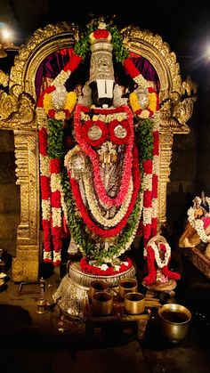 an idol is decorated with flowers and garlands