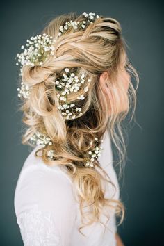 a woman with long blonde hair and flowers in her hair