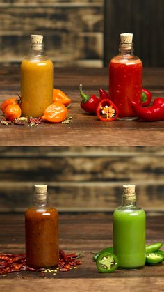 three bottles filled with different colored liquids sitting on top of a wooden table next to peppers