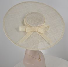 There is an elastic string with the base hat, it will help you to hold fascinator easier! Sinamay saucer hat base hat that measures approximately 18.5 inches side to side, front to back is also the same size, 18.5 inches, colors are available, black, off white, pink, hot pink and pink and lime green, it will help you to support for your millinery creations. Edges trimmed in matching grosgrain ribbon.it comes with an elastic!   💃1. All hats will be sent from Rockville, MD, 20850, using FedEx Gro Fitted Cream Hat Bands, Elegant Adjustable Beige Hat Bands, Adjustable Flat Brim Top Hat For Church, Classic Adjustable Cream Top Hat, Classic Adjustable Wide Brim Fascinator, Classic Wide Brim Adjustable Fascinator, Adjustable Sinamay Boater Hat With Curved Brim, Adjustable Cream Top Hat With Curved Brim, Fitted Cream Top Hat With Flat Brim