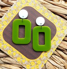 I have hand cast these 1960's mod style earrings in resin, using moss green for the rectangle hoops and  and fixed them to flat white studs.  The hoops measure 30mm x 40mm and the stud tops are 15mm in diameter. The earrings have a total drop of 58mm Lightweight and easy to wear, these colourful geometric earrings will add a burst of colour to any outfit and they will make the perfect gift for lovers of mid century fashion.   You can find more of my 60s inspired geometric earrings here: www.etsy White Studs, Mid Century Fashion, Rectangle Earrings, Mod Fashion, Geometric Jewelry, Moss Green, Geometric Earrings, Resin Jewelry, Statement Jewelry