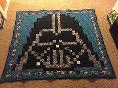 a star wars themed quilt on the floor