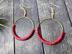 "These boho beaded hoop earrings are entirely handmade! I started by wrapping gold-colored 20 gauge German wire in the shape of a circle, then added the 25 4mm x 2mm red howlite (imitation turquoise) heishi beads by hand and wrapped the wire around itself to form and secure a loop. After that, I added a gold-plated surgical steel ear wire, making these earrings safe for the most sensitive of ears. Howlite is predominantly a calming stone. It is said to calm the overactive mind and relieve stress Bohemian Hoop Earrings With Wooden Beads For Gift, Red Hoop Earrings With Colorful Beads For Jewelry Making, Handmade Red Beaded Earrings For Beach, Red Beaded Earrings For Beach, Red Round Hoop Earrings For Festivals, Bohemian Wooden Beads Hoop Earrings Gift, Red Hoop Earrings For Festival, Bohemian Hoop Earrings With Wooden Beads, Red Round Earrings For Beach