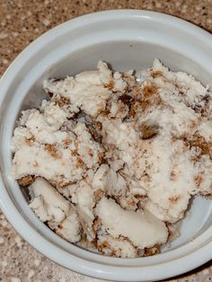 a white bowl filled with food on top of a counter