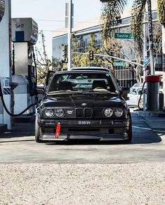 a black car is parked at a gas station