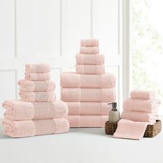 a stack of pink towels sitting on top of a table