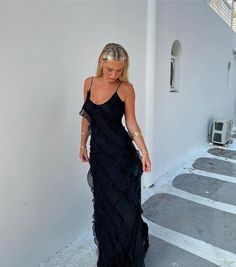 Step into a world of whimsical charm with our ruffle maxi dress, where glamour meets graceful movement. This dress features enchanting cascading ruffles that dance with each step you take. Designed to drape elegantly to the floor, it boasts an alluring scoop open back and a delicately low-cut bust, adding a touch of sultriness. The adjustable spaghetti straps allow for a custom fit, while the soft, floaty chiffon fabric provides an ethereal feel. Enhanced with exquisite ruffle detailing and fully lined for comfort, this maxi dress is a stunning choice for any occasion that calls for a touch of elegance.   Material: Chiffon - polyester, spandex blend. Sleeveless Maxi Dress With Ruffle Hem For Prom, Tiered Ruffle Dress For Night Out, Elegant Prom Maxi Dress With Ruffled Straps, Elegant Evening Maxi Dress With Ruffles, Flowy Party Dress With Ruffled Straps, Elegant Ruffled Maxi Evening Dress, Elegant Ruffled Maxi Dress For Evening, Elegant Maxi Dress With Ruffled Straps For Prom, Summer Gala Maxi Dress With Ruffled Straps