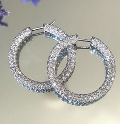 Elevate your look with these stunning 18kt white gold hoop earrings from Eternity. Featuring a total of 4.00ctw VS-F diamonds, these earrings are a perfect combination of elegance and luxury. The diamonds are expertly crafted to ensure maximum sparkle and shine, making them a perfect choice for any special occasion. The hoop style of these earrings is perfect to complement any outfit and make a statement. The 18kt white gold metal purity ensures that these earrings will last for years to come. Add these beautiful earrings to your collection today and make a statement wherever you go. All items we have listed are also displayed for sale in our retail location and if the item is sold we will remove the listing from Ebay.  All items are shipped via USPS Ground Advantage or Priority Mail with Luxury Diamond White Hoop Earrings With Sparkling Stones, Diamond White Luxury Diamond Cut Hoop Earrings, Dazzling Diamond-cut Hoop Earrings For Anniversary, Luxury Tarnish-resistant Diamond Hoop Earrings, Luxury Sterling Silver Diamond-cut Hoop Earrings, White Gold Hoop Earrings, White Gold Hoops, Sparkle And Shine, Diamond Eternity