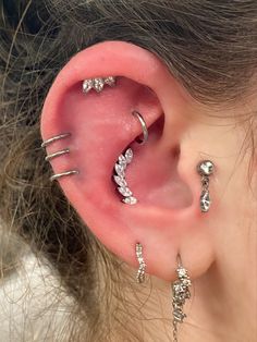 an ear with three different piercings attached to it