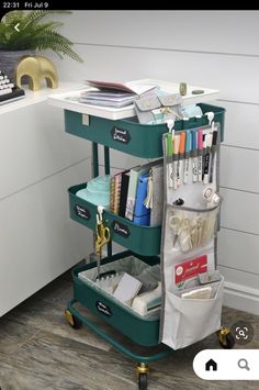 a green cart filled with lots of office supplies