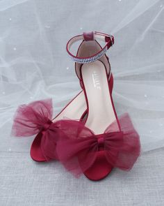 Classy satin block heel with oversized front tulle bow. Simple yet elegant are great combination and will definitely be a favorite.DETAILS:FIT: RUNS LARGE, ORDER ONE SIZE DOWNHEEL HEIGHT: 1.25 inches (kids) & 2 inches (women)RIBBON WIDTH: 1.5 inchesCOLORS AVAILABLE: Black, Burgundy, Champagne, Ivory, Navy, White, Light Blue, Soft BlushUPPER: Synthetic upper and liningMATERIALS: Mandmade outsole STYLE NAME: NAOMI Tulle Bow, Tulle Bows, Glitter Heels, Blue Soft, Heel Sandal, Dress Sandals, Block Heels Sandal, Navy White, White Light