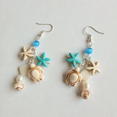 Marine theme handmade earrings, cute ocean inspired jewellery, ideal gift for her, sea themed earrings, lovely summer item. Sea themed item represent shell earrings with sea stars and turtle beads. Blue cat's eye beads (4 mm) add the charm of summer sea beach. Those nautical dangle & drop earrings are perfect for all occasions, wear this pair of earrings with traditional or modern outfit, say,  on beach summer cocktail party or during your city beach walk. Drop length is approx. 5.0 cm. All earrings metal parts are nickel-free and silver plated. Please, pay attention to FAQs and if you have any question, don't hesitate to ask.  Thanks for visiting my shop! Cheap White Ocean-inspired Earrings, Beach Artisan Earrings, Cheap Colorful Earrings For The Beach, White Starfish Earrings For Beach, Summer Starfish Charm Dangle Earrings, Summer Beach Earrings With Starfish Charm, Summer Dangle Earrings With Starfish Charm, Handmade Cute Jewelry For Vacation, Cute Adjustable Earrings For Beach