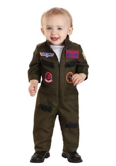 a toddler wearing an army green space suit with patches on the chest and feet