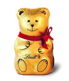 a gold foil wrapped teddy bear with a red ribbon