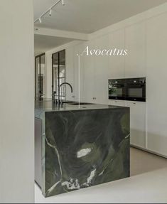 a kitchen with marble counter tops and an island in front of the stove top oven