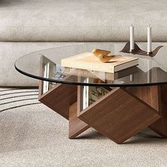 a glass table with books on it in front of a couch