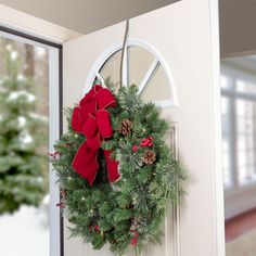 a christmas wreath hanging on the front door