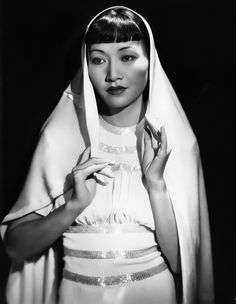 an old black and white photo of a woman wearing a veil