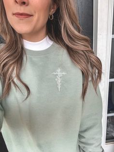 Embroidered Floral Cross Sweatshirt Color: Stonewash Green Fit: Unisex, Fits loose/relaxed Sizing: S,M,L,XL,2XL Material: 50% Cotton, 50% Polyester Embroidery Details: Floral Cross placed on the left of chest (over the heart) Floral Cross Embroidery, Embroidered Cross Design, Green Embroidered Crew Top, Green Embroidered Crew Neck Top, Green Embroidered Long Sleeve T-shirt, Casual Long Sleeve Top With Contrast Embroidery, Long Sleeve T-shirt With Embroidered Text, Oversized Floral Embroidery Crew Neck Top, Oversized Floral Embroidered Crew Neck Top