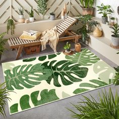 a living room with lots of plants on the floor and rugs in front of it