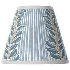 a blue lamp shade with leaves on it