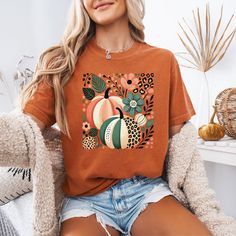 Embrace the holiday season with our Comfort Colors® "Retro Floral Pumpkin" T-shirt! Welcome to Christi Creations! Here you will find that unique outfit for a special occasion! We have been in business over 14yrs here on Etsy and can assure you that you will receive 5 Star service! Thank you for supporting our small family business:) This listing is for the "Retro Floral Pumpkin" t-shirt as shown. The brand of this tee is Comfort Colors® which is a soft, high quality tee. Shirts are available in Multicolor Tops For Holiday Fall Season, Multicolor Tops For Fall Holiday, Multicolor Tops For Holiday In Fall, Multicolor Short Sleeve Shirt For Fall, Fall Season Printed Short Sleeve Shirt, Printed Short Sleeve Shirt For Fall, Fall Graphic Tee Shirt With Printed Details, Fall Graphic Tee With Printed Design, Graphic Tee Shirt With Fall Print