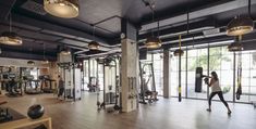 a woman is exercising in the gym with an exercise machine and other personal training equipment