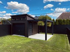 a backyard with a shed and two garages