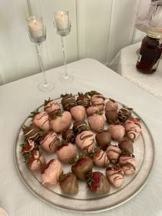 chocolate covered strawberries are arranged on a silver platter