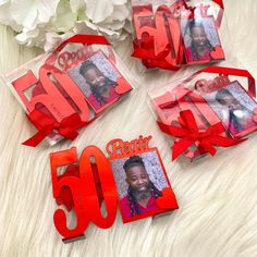 three red gift bags with the number 50 and an image of a woman on them