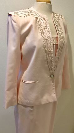 "Light Pink Beaded Detail 3 piece Special Occasion Designer Suit by Della Roufogali ladies size 8 D*E*S*C*R*I*P*T*I*O*N Jacket; Gorgeous 3 piece suit has a lot to love. Jacket has stunning silver, beads, pearls and rhinestones, exclusive of decoration on shoulders, upper back, and going down front sides. More features are; Stunning single & large rhinestone with pearl button for closure, with smaller but matching buttons at end of arms sleeves... Fully lined, fabric content is 65% Polyester Elegant Pink Three-piece Suit For Formal Occasions, Pink Three-piece Suit With Suit Collar For Formal Occasions, Luxury Pink Outerwear With Buttons, Elegant Pink Button-up Outerwear, Elegant Pink Single-breasted Outerwear, Kick Pleat, Arm Sleeve, 3 Piece Suits, Padded Jacket