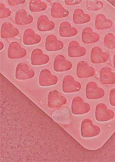 a pink heart shaped ice tray sitting on top of a counter