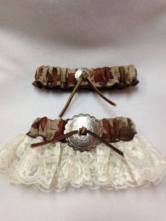 "Everyone needs a something fun and unique for their special day. Create your own beautiful, one of a kind Bridal Garter Set.  \"All is Autumn\"  The Keepsake Garter (Bridal Garter) is autumn leaves on burlap, ivory antique embellished with silver tone concho.    The Toss Garter is autumn leaves on burlap, embellished with silver tone.  Garter size fits up to 22\". Customer orders for sizes and embellishments are available  for an additional charge depending on the customization.  Order includes Western Garter, Wedding Garder, Garter Set Wedding, Western Weddings, Country Western Wedding, Bride Garter, Bridal Garter Lace, Bridal Garters Set, Leg Garter