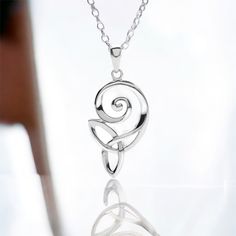 Featuring the Celtic swirl and a Trinity knot, this pendant is beautifully unique! Note the beautiful angles on the silver rope. It is highly polished .925 sterling silver and is available in several chain lengths. There are matching earrings - NHI9221.The swirl depicts life's never-ending journey. The Celts believed that continuous rebirth was needed to obtain complete spiritual fulfillment.The Trinity knot symbolizes the Holy Trinity - the Father, the Son and the Holy Spirit.Questions? Email: info@celticelegance.com Spiritual Fulfillment, The Celts, Celtic Trinity Knot, The Holy Trinity, Celtic Heart, Celtic Pendant, Celtic Wedding, Trinity Knot, The Trinity