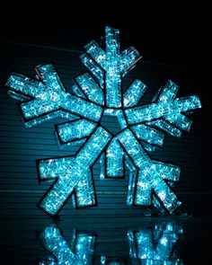 an illuminated snowflake is shown in the dark