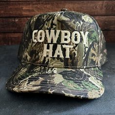 Vintage Style Cowboy Hat Embroidered Camouflage Canvas Snapback Trucker Rope Hat with Free Shipping. White stitched text/logo. Condition is "New with tags". Shipped with USPS First Class. *Condition is "New with tags". Shipped with USPS First Class. *This is a medium profile hat that will fit most medium to large sized heads  *Please feel free to message us questions about the fit; we don't mind!  *Each listing includes 1 vintage style mesh back trucker hat with an embroidered design.   If this Military Camouflage Trucker Hat With Flat Brim, Camouflage Trucker Hat One Size, Military Style Camouflage Trucker Hat With Flat Brim, Camouflage Trucker Hat One Size Fits Most, Flat Brim Dad Hat With Letter Print For Outdoor, Camouflage Trucker Hat For Hunting With Curved Brim, Camouflage Snapback Trucker Hat For Hunting, Camouflage Flat Brim Trucker Hat For Outdoor, Camouflage Trucker Snapback Hat