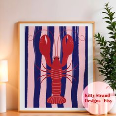 a framed art print of a lobster on a pink and blue striped background with the words kitty strand designs easy