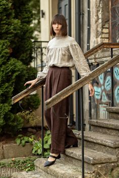 "Edwardian-like loose linen top full of delicate details. Elegant and modest, yet far from simple. In the photos, you see it in our Natural linen: non-dyed, suitable even for the most sensitive skin. STYLE DETAILS * Loose fit * High, ruffle collar * Gathered chest * Long, balloon / bishop sleeves with elastic wrists * Ties at the back * Made from medium-weight and exclusive linen SIZES & COLORS IN THE PICTURES * Model 1 is wearing S/M in Natural (medium-weight).   Model's height - 176 cm (5' Linen Tank Top, Linen Tank, Unique Blouse, Ruffled Collar, Linen Blouse, Ruffle Collar, Puffy Sleeves, Linen Top, Natural Linen