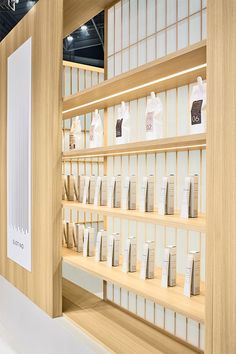 the shelves are filled with many different types of items in white and light brown wood