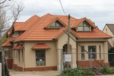 a small house with a red tiled roof