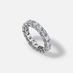 a white gold and diamond ring on a gray background with the words love written across it