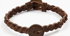 a brown leather bracelet with a button on it