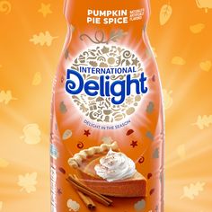 an advertisement for international delight pumpkin pie with whipped cream and cinnamon on the top, in front of an orange background