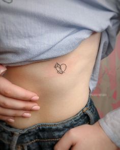 a woman with a small tattoo on her stomach