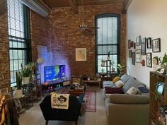 a living room filled with furniture and lots of windows